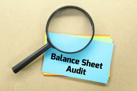 colored paper, magnifying glass with the words balance sheet auditの写真素材