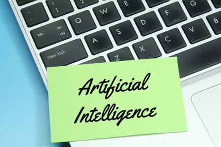 laptop keyboard, colored paper with the word artificial intelligence