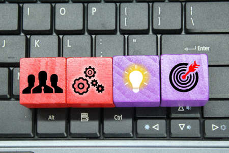 laptop, colored cubes with management icons, teamwork, ideas and targets. business conceptの写真素材
