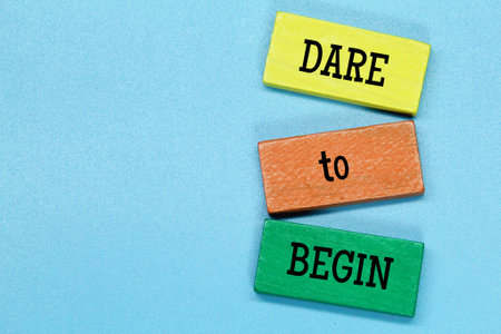 colored board with the word dare to beginの写真素材