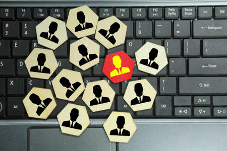 laptop keyboard, hexagon with worker and a red worker. business concept