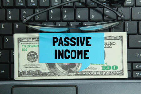 laptop keyboards, glasses, colored paper with the words Passive Income