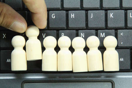 peg dolls lined up and one was chosen. the concept of choosing a good employee leaderの写真素材