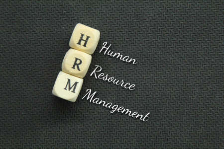 wooden cubes with the letters HRM and the words Human Resource Managementの写真素材