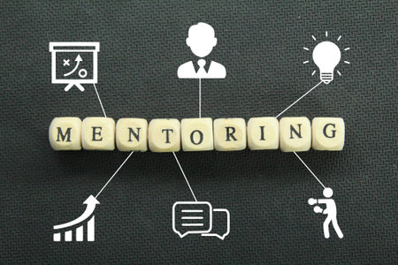 wooden cubes with the word mentoring and icons for mentorsの写真素材