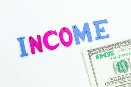 banknotes and letters of the alphabet colored with the word Incomeの写真素材