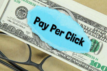 glasses, banknotes, torn paper with the words Pay Per Clickの写真素材