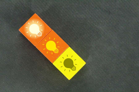 colored cubes with bulb icons from a gloomy bottom and a bright top. Idea conceptの写真素材