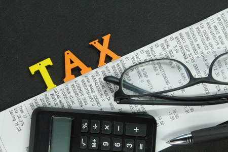 Malaysia, kuala Terengganu 6 Ogos 2021 : glasses, pens, receipts, calculators with the word TAX. Business conceptのeditorial素材