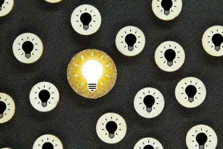 one bulb lit bright and the other dim. concept ideaの写真素材