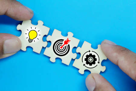 puzzles with icons of ideas, targets and management. the concept of business success