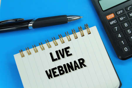 calculator, pen, notebook with the word Live Webinar