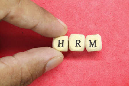 wooden cubes with the letters HRM and the words Human Resource Managementの写真素材
