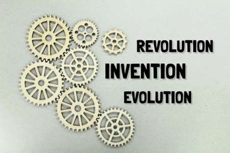 wooden wheel teeth with the words innovation, revolution and evolutionの写真素材