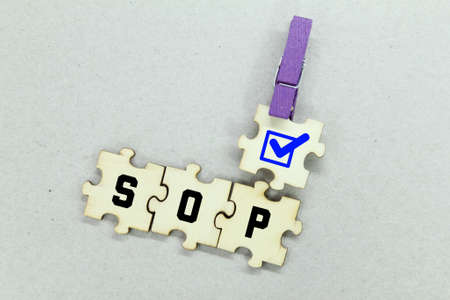 wooden puzzles with SOP words or letters and correct signsの写真素材