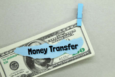 torn paper, paper money clamped with the word money transferの写真素材