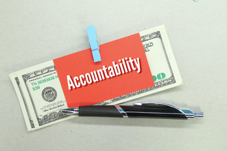 banknotes, pens, colored paper with the word Accountabilityの写真素材