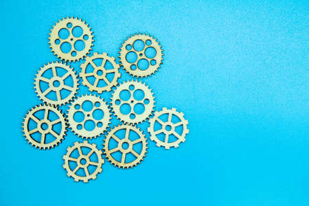 gear wheels or wooden gear teeth with a blue backgroundの写真素材