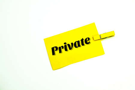 yellow paper clamped with the word Private. Privacy and policyの写真素材