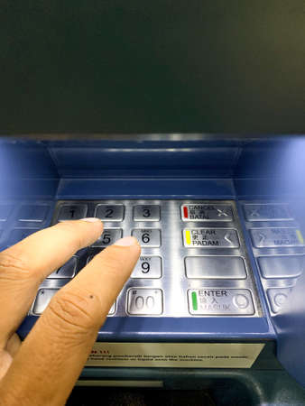 Malaysia, kuala Terengganu 19 November 2021: the hand is pressing the pin number on the ATM machineのeditorial素材