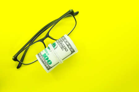the concept of money and glasses or making moneyの写真素材