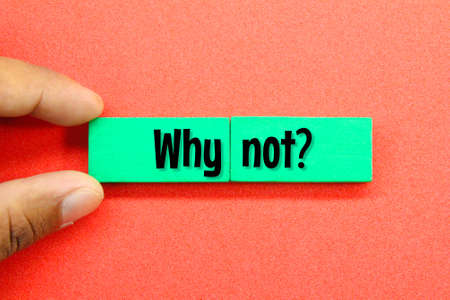 hands holding a colored board with the word Why Not or the question Why Notの写真素材