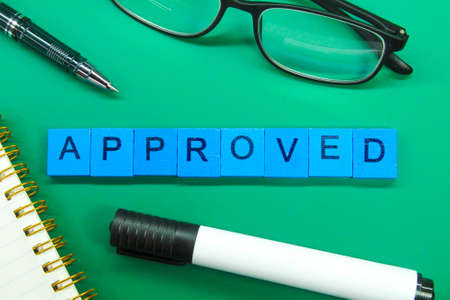 glasses, thought, notebooks with the word Approved. the concept of check marksの写真素材