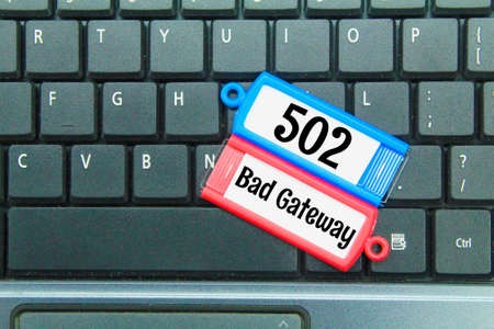 laptop keyboard, colored tag with the word 502 bad gateway