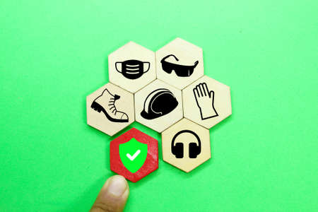 The hand pushes the hexagon with the safety icon. the concept of workplace safety Or Safety at work.の写真素材