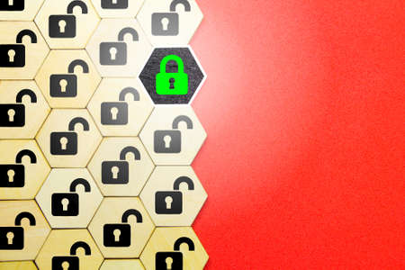 a hexagon with a lock icon opened and one locked. padlock for cybersecurity. the concept of safetyの写真素材