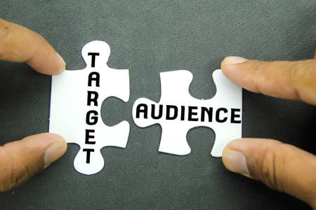 hand holding jigsaw puzzle with the word Target audienceの写真素材