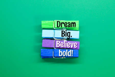 colored clamps with the words Dream big, believe boldの写真素材