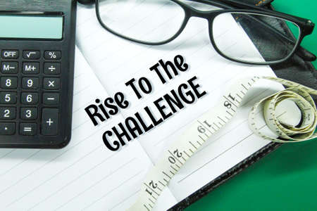 glasses, measuring straps, calculators and notebooks with the words rise to the challenge