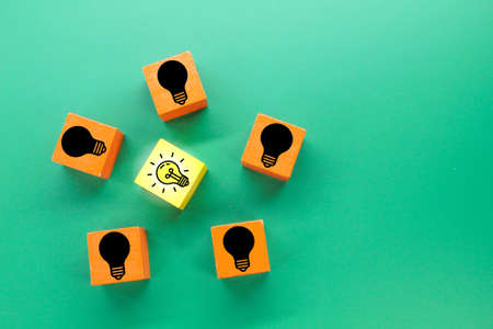 colored cubes with light bulb icons on lit and dim bulbsの写真素材