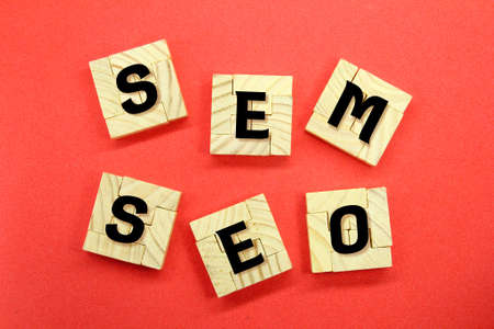 flat wooden puzzles arranged in compartments with the words SEM and SEOの写真素材