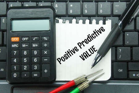 laptop keyboards, arrows, calculators and paper with the word positive predictive value