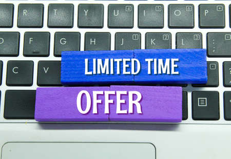 laptop keyboards and colored boards with the words LIMITED TIME OFFERの写真素材