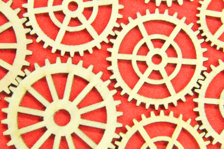 wooden gear wheels full of red backgroundの写真素材