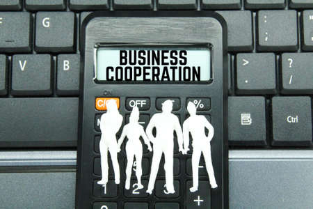 calculators and white people models with the word business collaboration. business cooperationの写真素材