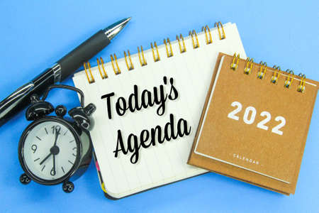 pens, alarm clocks, calendars and notebooks with the words Todayâ€™s Agenda
