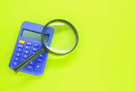 calculator and magnifying glass with side copy space. the concept of account managementの写真素材