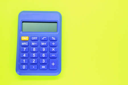 isolated blue calculator with yellow background. computational concept