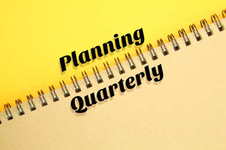 the notebook is slanted with the word planning quarterlyの写真素材
