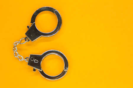 handcuffs with an orange background. error conceptの写真素材