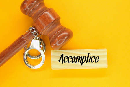 hammers, handcuffs and wooden boards with the word accomplice