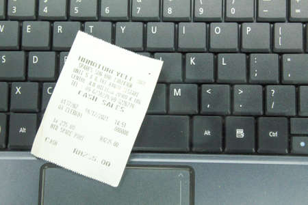 receipts and laptop keyboards. the concept of spending