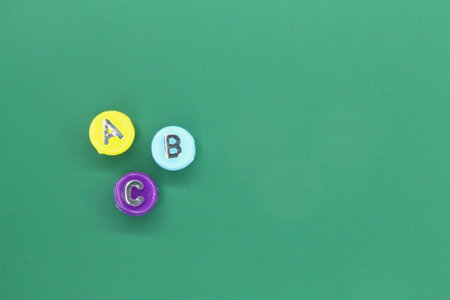 Letters of the alphabet on small circles with copy space on the edgesの写真素材