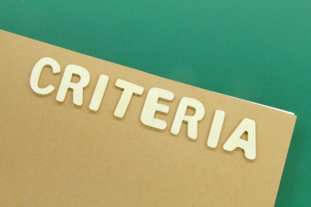 a notebook with the word criteria arranged on the cover of the book