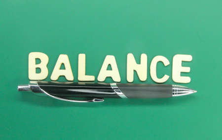 pen with wooden letters or the word balanceの写真素材