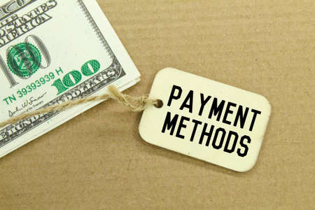 banknotes and wooden tags with the words payment methodsの写真素材